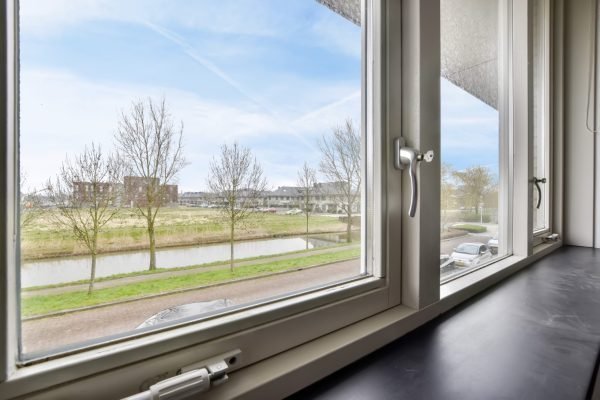 Beautiful view from the window to the street, the flowing river and the city landscape