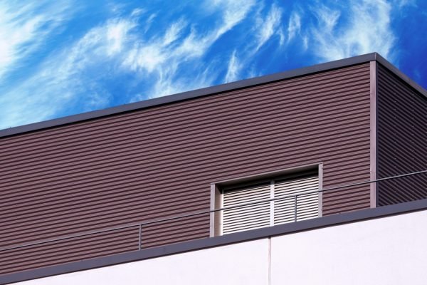 Abstract looking modern building detail against blue cloudy sky